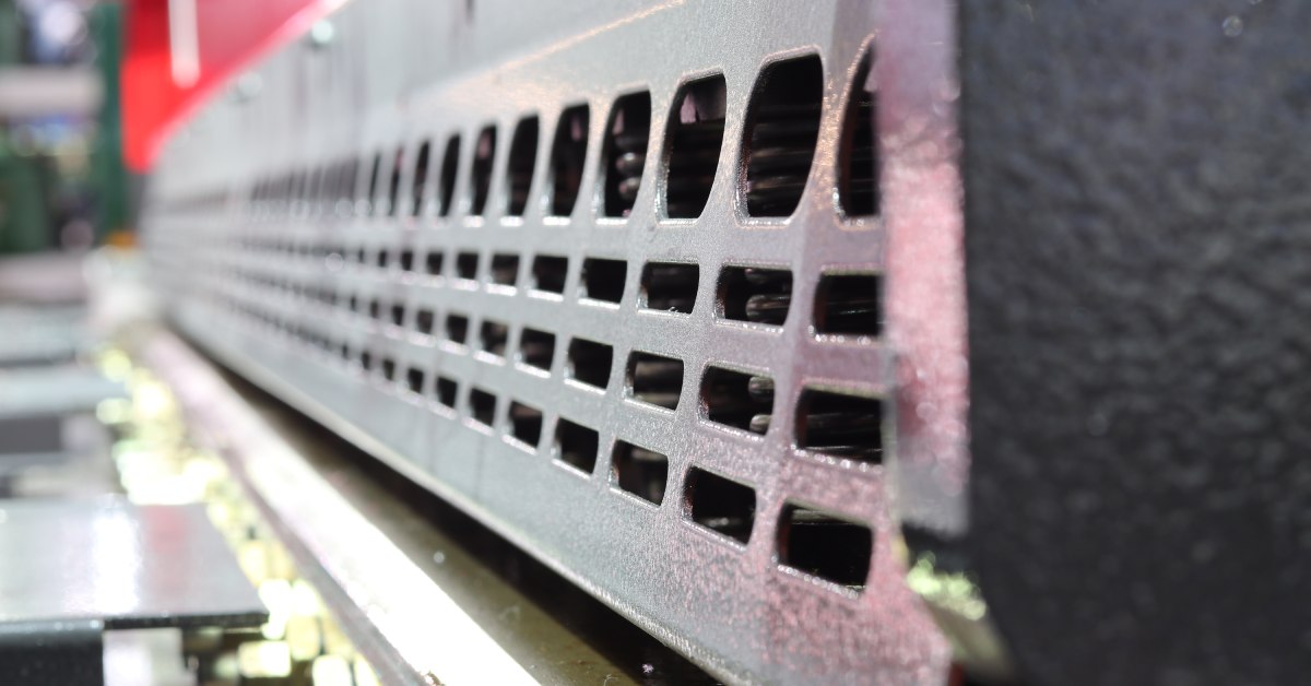 Close-up image of metal machine guarding equipment, showing the space that keeps employees safe from machines.