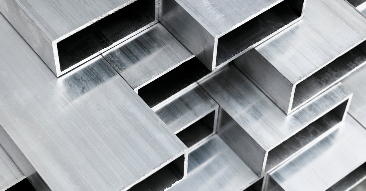 Rectangular aluminum profiles all stacked on top of each other. Each one has small lines across the top.