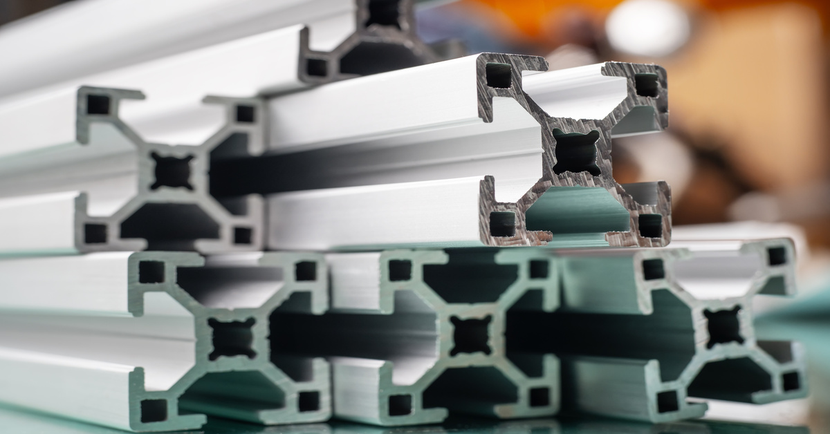 A group of aluminum system profiles stacked on top of each other. They are t-slot extrusion systems.