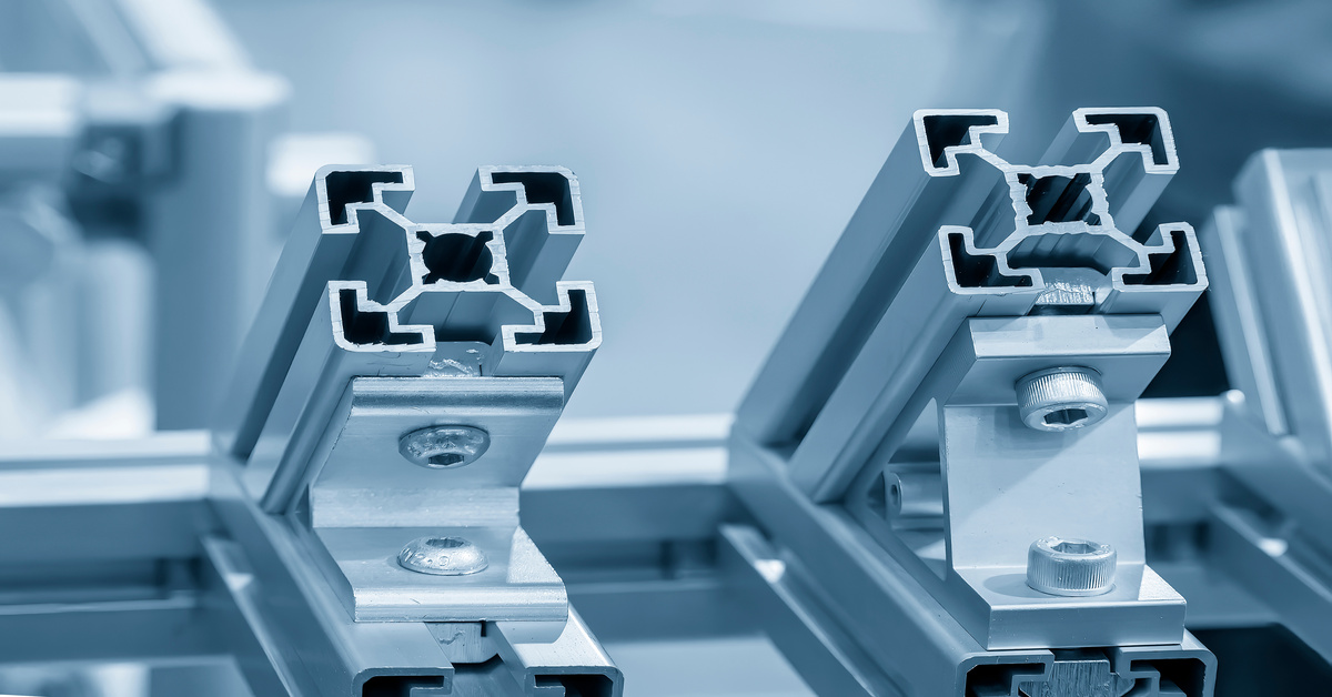 Components of a structure made from aluminum extrusions. The aluminum has a square frame with a hole in the center.