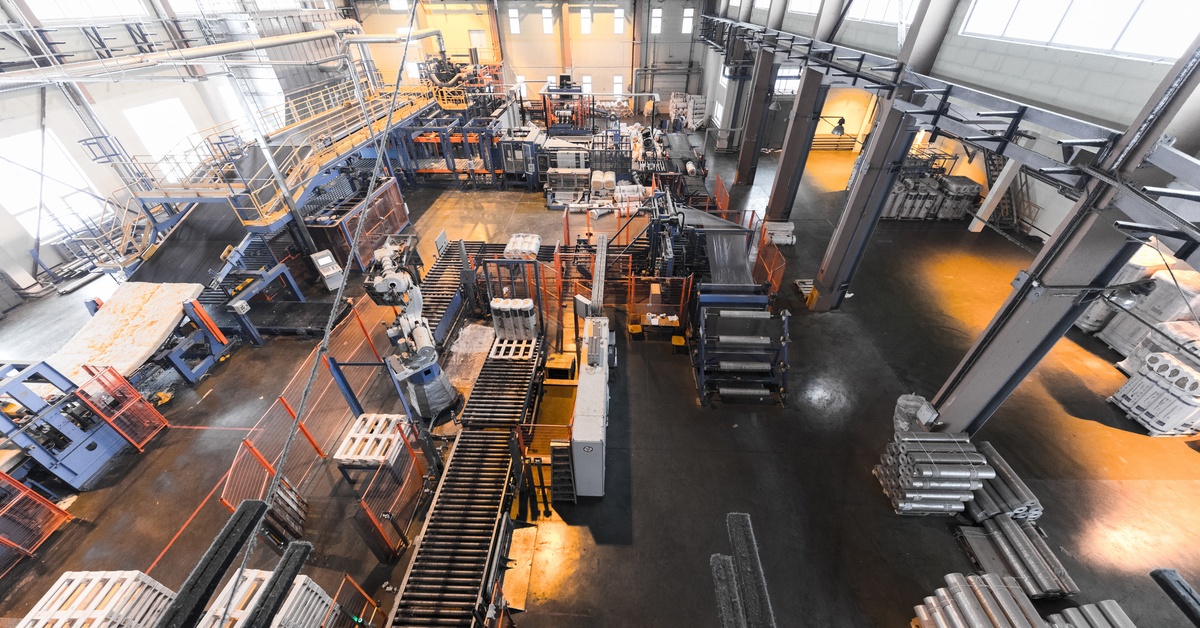An overhead view of a large manufacturing facility with different work areas set up for employees.